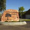 Cottonwood Grove entrance sign carved in stone with landscaped planter
