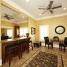 Clubhouse kitchenette with bar seating and dining tables