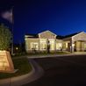Community clubhouse and entrance sign at dusk