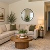 Living room with sectional sofa, round coffee table, and view toward the hallway