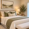 Primary bedroom with upholstered headboard, green accent bedding, and bench