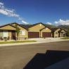 Street view of townhomes with garages and landscaped lawns
